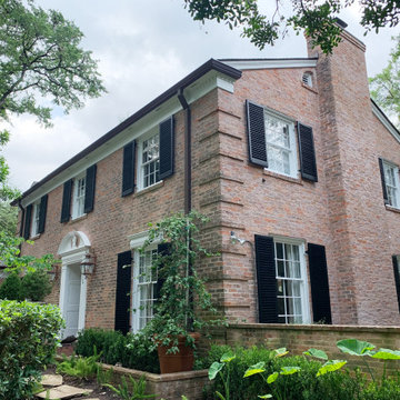Traditional Brick Classic Home with White Trim and Black Shutters