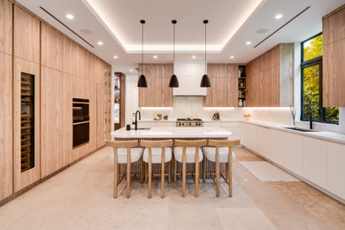 Example of a mid-sized trendy l-shaped marble floor and beige floor open concept kitchen design in Miami with an undermount sink, flat-panel cabinets, light wood cabinets, quartz countertops, white backsplash, stone slab backsplash, paneled appliances, an island and white countertops