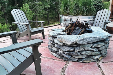 Photo of a mid-sized rustic backyard landscaping in Denver with a fire pit.