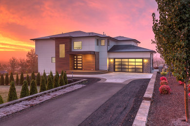 Large minimalist gray two-story mixed siding house exterior photo in Other with a shingle roof and a hip roof
