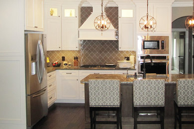 Large trendy l-shaped dark wood floor eat-in kitchen photo in Chicago with white cabinets, granite countertops, brown backsplash, ceramic backsplash, black appliances and an island