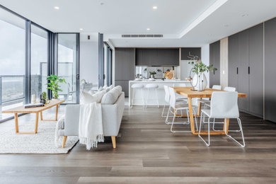 Mid-sized contemporary open plan dining in Wollongong with white walls.