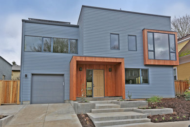 Example of a mid-sized trendy blue two-story mixed siding exterior home design in Portland