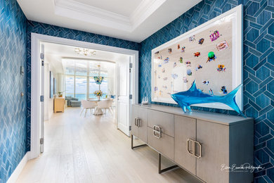 Mid-sized beach style foyer with blue walls, light hardwood floors, a double front door, a white front door, beige floor, recessed and wallpaper.
