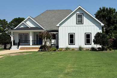 Large craftsman white two-story vinyl and board and batten exterior home idea in Other with a shingle roof and a gray roof