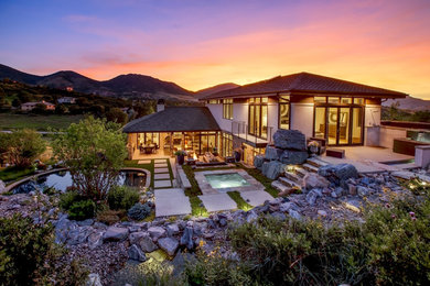 Inspiration for a large contemporary backyard kidney-shaped natural pool in Denver with a hot tub and concrete pavers.