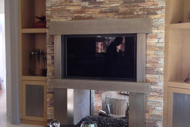 Family room - mid-sized contemporary open concept ceramic tile family room idea in Los Angeles with beige walls, a standard fireplace and a metal fireplace