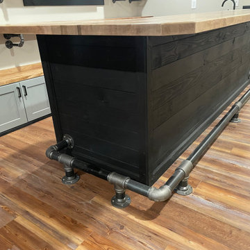 Industrial Basement Bar Island with Custom Iron Pipe Foot Rail — Gahanna, Ohio
