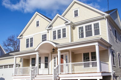 Example of a large classic beige two-story wood gable roof design in Newark