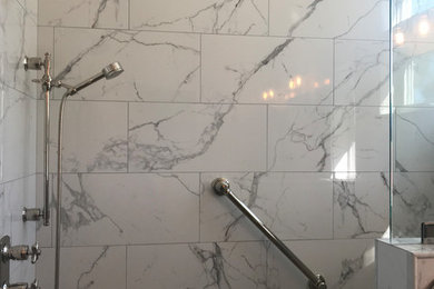 Example of a trendy brown floor bathroom design in Orange County with white walls, an undermount sink, quartzite countertops, a hinged shower door and gray countertops