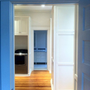 Large contemporary kitchen pantry designs - Example of a large trendy galley medium tone wood floor kitchen pantry design in Jackson with a drop-in sink, recessed-panel cabinets, white cabinets, white backsplash, stainless steel appliances and an island