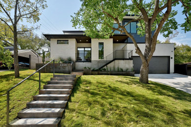 Inspiration for a mid-sized 1950s white two-story stone and clapboard exterior home remodel in Austin with a metal roof and a gray roof