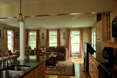Inspiration for a large timeless formal and open concept medium tone wood floor living room remodel in New York with beige walls and a tv stand