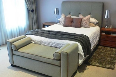 Mid-sized trendy master carpeted bedroom photo in Other with purple walls