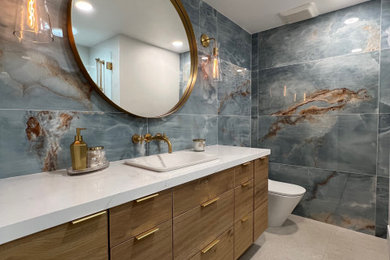 Example of a mid-sized beach style single-sink bathroom design in Los Angeles with flat-panel cabinets, light wood cabinets, quartz countertops, white countertops and a floating vanity