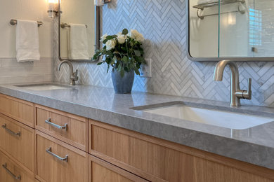 Mid-sized transitional kids' white tile and marble tile marble floor, white floor and double-sink bathroom photo in San Francisco with recessed-panel cabinets, light wood cabinets, a one-piece toilet, white walls, an undermount sink, quartz countertops, a hinged shower door, gray countertops, a niche and a built-in vanity