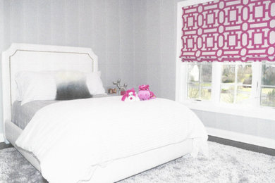 Example of a large minimalist girl carpeted and gray floor kids' room design in New York with gray walls