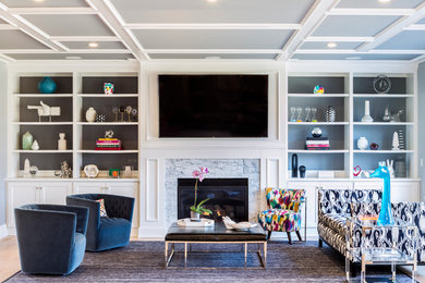 Example of a large transitional open concept light wood floor and brown floor family room design in New York with gray walls, a standard fireplace, a wall-mounted tv and a stone fireplace