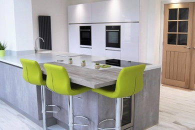 Inspiration for a large modern kitchen in Other with composite countertops, stainless steel appliances and an island.