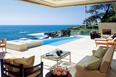 Large trendy backyard stone and custom-shaped infinity hot tub photo in Los Angeles