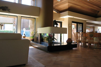Photo of a mid-sized formal open concept living room in Other with beige walls, ceramic floors, a corner fireplace, a plaster fireplace surround, no tv and beige floor.
