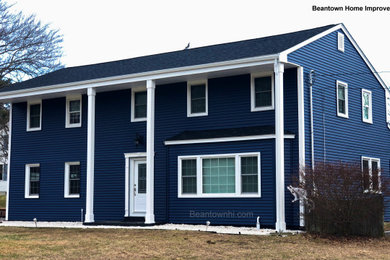 Example of a classic blue vinyl exterior home design in Boston with a shingle roof