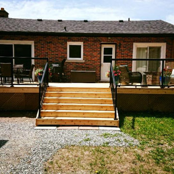 New Deck with Custom Privacy Wall and Glass Railing.