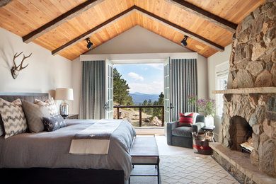 Inspiration for a large rustic master bedroom remodel in Denver with white walls and a standard fireplace