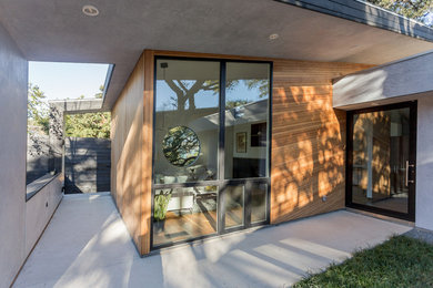 Inspiration for a mid-sized modern black one-story wood flat roof remodel in Austin