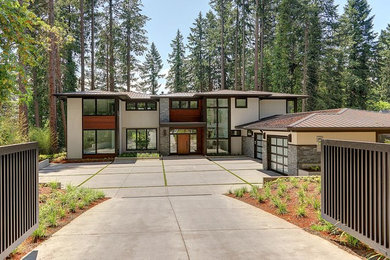 Example of a large trendy white two-story mixed siding house exterior design in Portland with a hip roof and a green roof
