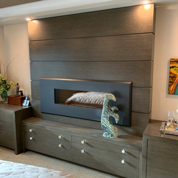 Master bedroom fireplace with custom millwork wall and built-ins