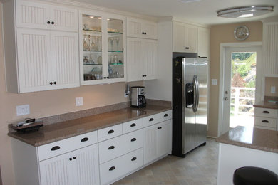Inspiration for a mid-sized transitional single-wall porcelain tile and beige floor enclosed kitchen remodel in San Diego with recessed-panel cabinets, white cabinets, granite countertops, stainless steel appliances, an island and a double-bowl sink