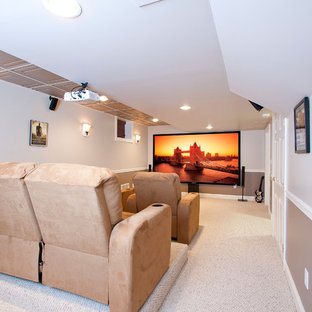 Photo of a medium sized traditional enclosed home cinema in Newark with multi-coloured walls, carpet, a projector screen and beige floors.