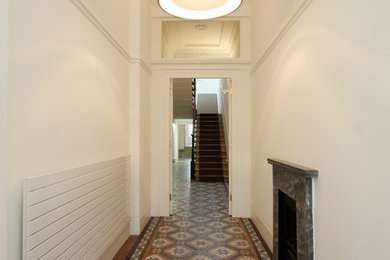 Inspiration for a large contemporary hallway in London with white walls and ceramic floors.