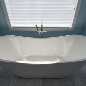 Traditional master bath utilizing frosted and clear glass to allow for needed pr