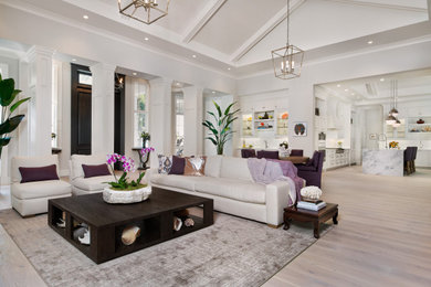 Large beach style open concept light wood floor and vaulted ceiling living room photo