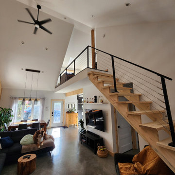 Indoor black metal post cable railing project in Saguenay, Quebec
