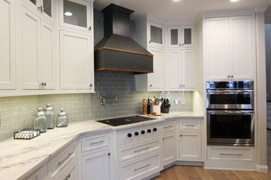 Inspiration for a mid-sized transitional single-wall medium tone wood floor and brown floor open concept kitchen remodel in Other with an undermount sink, shaker cabinets, white cabinets, marble countertops, gray backsplash, glass tile backsplash, stainless steel appliances, an island and white countertops