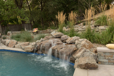Photo of a transitional backyard garden in San Francisco with with waterfall.
