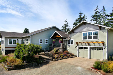 Example of a large farmhouse green split-level concrete fiberboard exterior home design in Other with a shingle roof