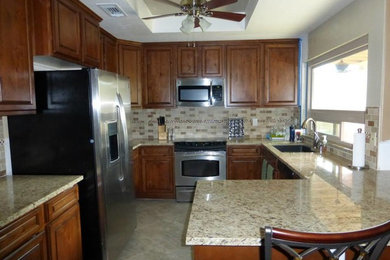 Inspiration for a mid-sized timeless terra-cotta tile kitchen remodel in Phoenix with white cabinets