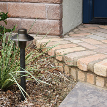 Coastal Cottage with Natural Stone Wall and Rustic Brick Pathways