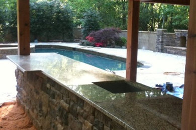 Inspiration for a large back porch remodel in Charlotte with an awning