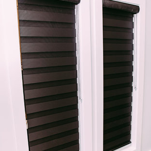 Large modern home office and library in Edmonton with grey walls, ceramic flooring and a hanging fireplace.