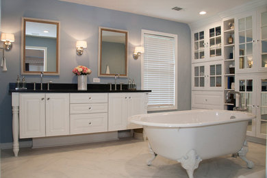 Example of a mid-sized transitional master white tile and mosaic tile marble floor and white floor bathroom design in Other with raised-panel cabinets, white cabinets, a two-piece toilet, blue walls, an undermount sink, solid surface countertops and a hinged shower door
