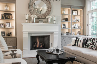 Elegant open concept brown floor family room photo in Other with beige walls, a standard fireplace and a wood fireplace surround