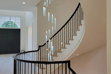Staircase - huge mediterranean wooden curved metal railing staircase idea in DC Metro with painted risers