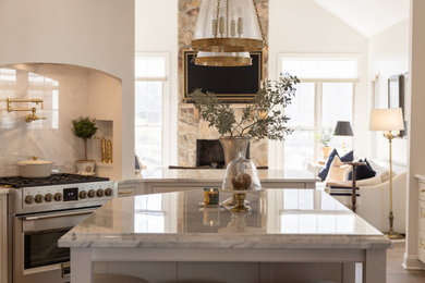 Mid-sized transitional kitchen photo in DC Metro with shaker cabinets, quartzite countertops and an island