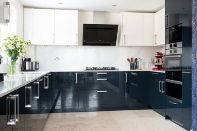 Medium sized contemporary u-shaped kitchen/diner in Berkshire with flat-panel cabinets, blue cabinets, quartz worktops, black appliances, no island and white worktops.