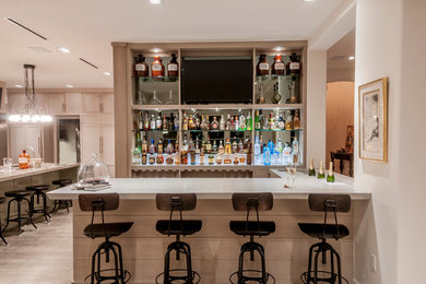 Inspiration for a large contemporary galley dark wood floor seated home bar remodel in Miami with an integrated sink, flat-panel cabinets, light wood cabinets, concrete countertops and mirror backsplash